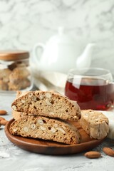 Traditional Italian almond biscuits (Cantucci) on grey textured table, closeup