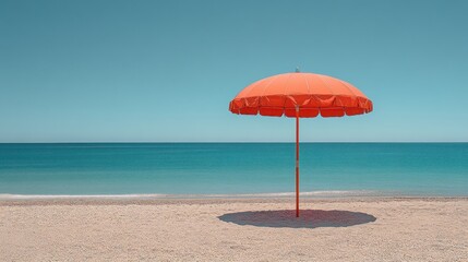Single orange beach umbrella on sandy shore.