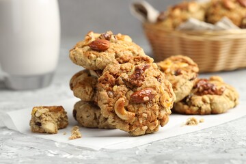 Tasty cookies with nuts on grey table, closeup