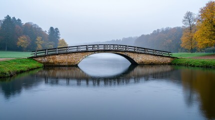 Obraz premium Serene ambiance and relaxing spiritual, A serene scene featuring a misty landscape with a wooden bridge arching over calm water, surrounded by autumn foliage.