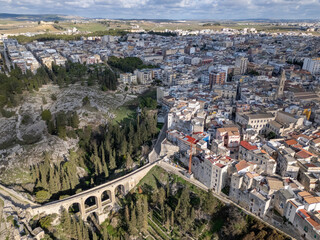 Fototapeta premium Aerial drone photo of the old Roman bridge in the town named Gravina in Puglia in southern Italy.