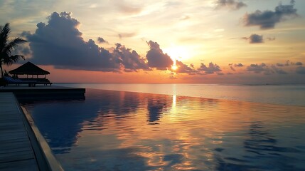 Glowing sunset over calm ocean horizon with soft sky tones and water reflections in Maldives