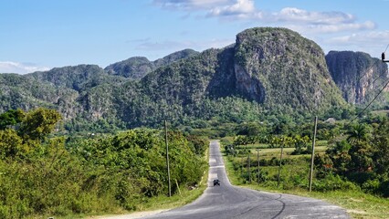 beautiful surroundings of Vi&ntilde;ales on cuba with a  car on the road 