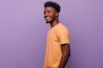 Obraz premium Smiling young African American man in casual orange t shirt