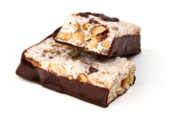 Chocolate chip nougat bar with dark chocolate coating, isolated on white background.