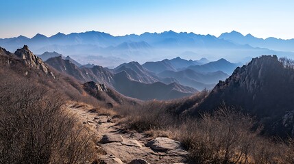 Wide mountain view with jagged cliffs and sharp ridges under a clear sky