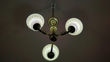 an old lamp in a hotel on the ceiling 