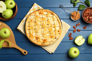 Flat lay composition with tasty homemade apple pie and ingredients on blue wooden table