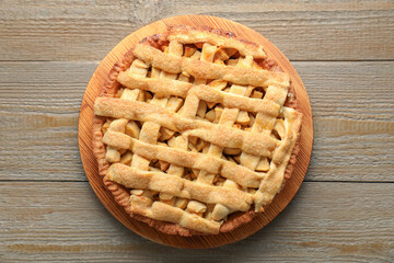 Tasty homemade apple pie on wooden table, top view