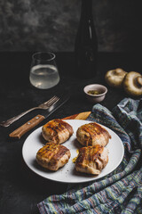 Bacon-wrapped button mushrooms stuffed with cheese