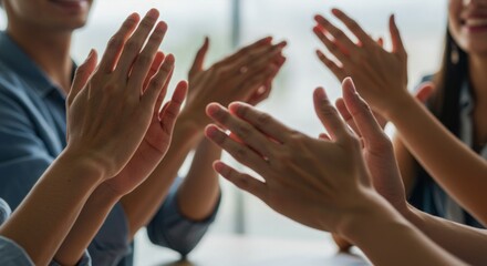 Close-up of hands clapping in a group, celebrating success