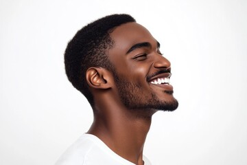 Obraz premium Close up profile portrait of handsome young black man laughing against isolated white background