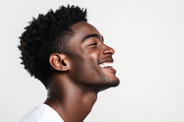 Close up profile portrait of handsome young black man laughing against isolated white background
