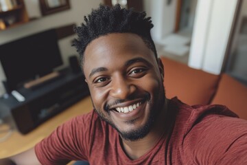 Smiling African American man takes selfie at home.