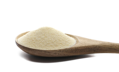 Pile of uncooked organic semolina in wooden spoon isolated on white, side view