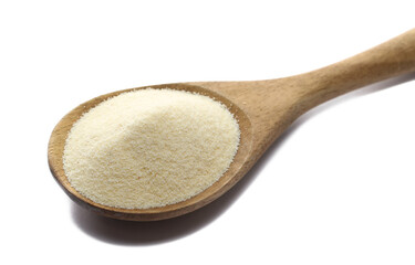 Pile of uncooked organic semolina in wooden spoon isolated on white, side view