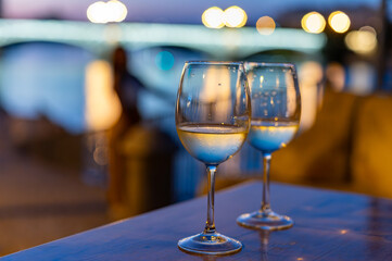 Two glasses of cold dry white wine served outdoor in cafe at night in historical Triana district, Sevilla, Spain, close up