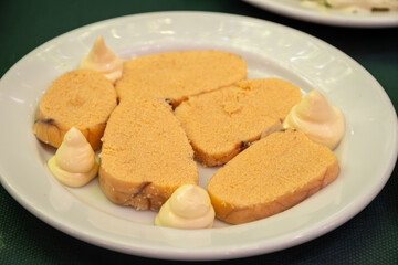 Traditional andalusian dish fish eggs seafood served with mayonnaise sauses in old tavern as tapa, Sanlucar de Barrameda, Spain