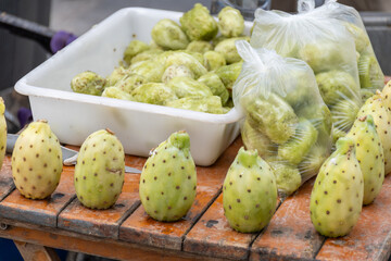 Ripe juicy edible fruits opuntia prickly pears cacti for sale on Triana farmer market in Sevilla,...