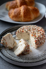 French cheese collection, fresh white soft goat cheese with aromatic herbs, garlic, parsley and red peppers close up
