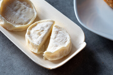 Rocamadour or cabecous soft goat AOC cheese with soft rind produced on farm in Perigord and Quercy on farmers market, departement Lot, France