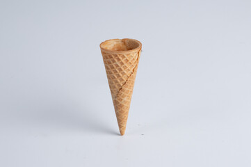 Image of a sugar ice cream cone placed 
on a white background.