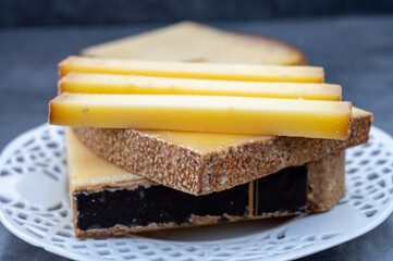 French yellow cheese Comte, varieties unpasteurised cow milk Prestige, fruity flavoured Fruite and Vieille Reserve close up
