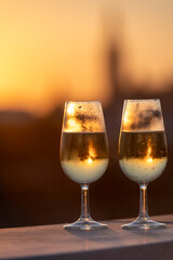 Drinking of cava or champagne sparkling wine on outdoor roof terrace with view on central part of old Sevilla, Andalusia, Spain sunset