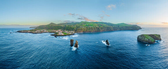 Aerial view on the west side of the isle of Sao Miguel with the village of Mosteiros at sunset, Azores Portugal