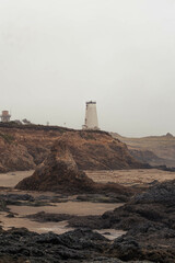 lighthouse on a misty coastline
