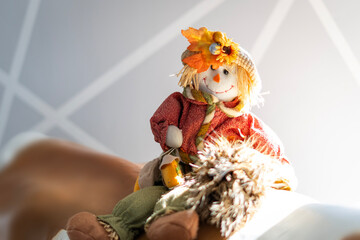 Autumn scarecrow decoration in sunlight