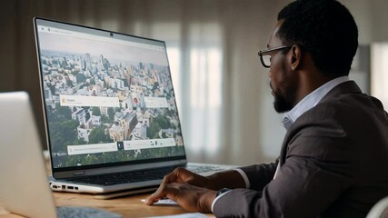 Businessman browsing map on laptop