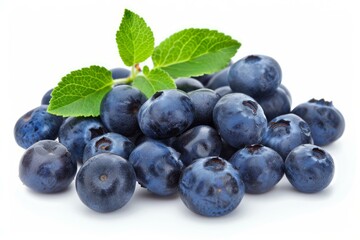Fototapeta premium Freshly picked blueberries with leaves are piled on a white background