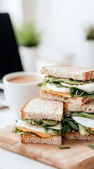Breakfast at the workplace, sandwiches with eggs and lettuce, laptop and a cup of coffee in the background, coupled plan