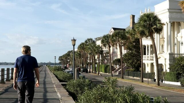 A man walks along the waterfront in historic Charleston, South Carolina