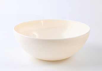 An empty cream-colored kitchen food bowl on a white background