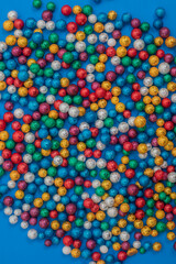 Top view of multi colored balls on a blue background