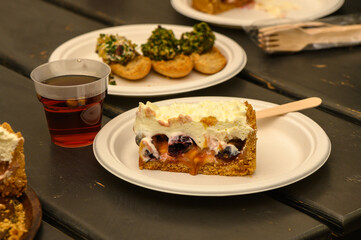 Delightful summer dessert served with fruit and refreshing drink on rustic outdoor table