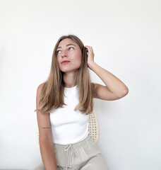 Young woman posing thoughtfully in modern indoor space during daylight hours