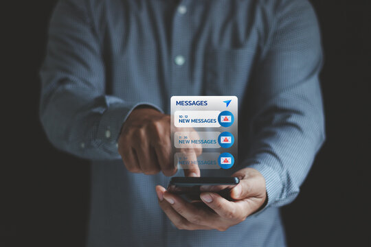 Email hack, System hacked warning alert, SMS spam, and fake text message phishing concept. scam malware spreading virus on messages alert virtual on mobile smart phone screen in businessman's hand.