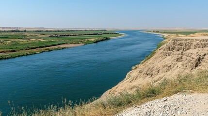 Obraz premium Serene river winding through a dry landscape.