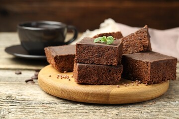 Delicious chocolate puffed rice bars and mint on wooden table, closeup