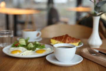 Delicious breakfast served on wooden table in cafe