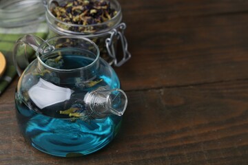 Delicious butterfly pea flower tea on wooden table. Space for text