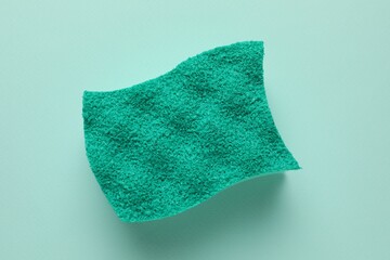 One sponge on light blue background, top view