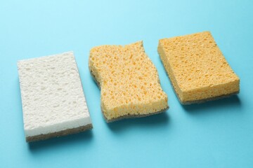 Many sponges on light blue background, closeup