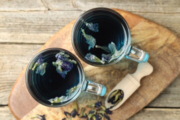 Delicious butterfly pea flower tea on wooden table, top view © New Africa