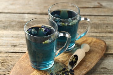 Delicious butterfly pea flower tea on wooden table, closeup