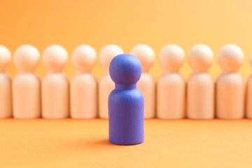 Blue human figure in front of wooden ones against orange background, closeup. Competition concept