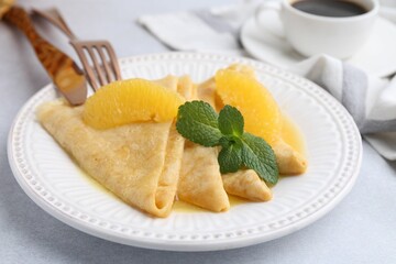 Delicious Crepes Suzette served on light table, closeup